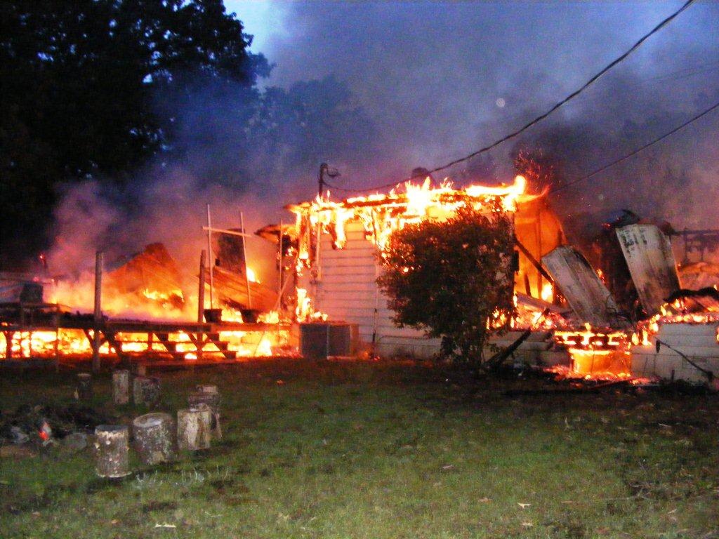 House completely engulfed in flames.